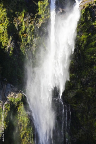 Stunning view of a waterfall cascading down a mountain cliff in Fjordland South Island, New Zealand.