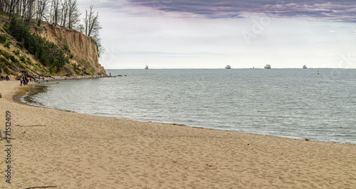 Fototapeta Naklejka Na Ścianę i Meble -  Baltic Sea at the bay of Finland with sun setting on the horizon large ships in the Baltic Sea on the roadstead 