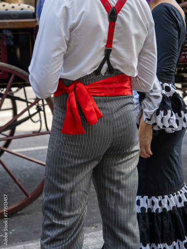 Detail of man with traditional Andalusian country pants with red sash
