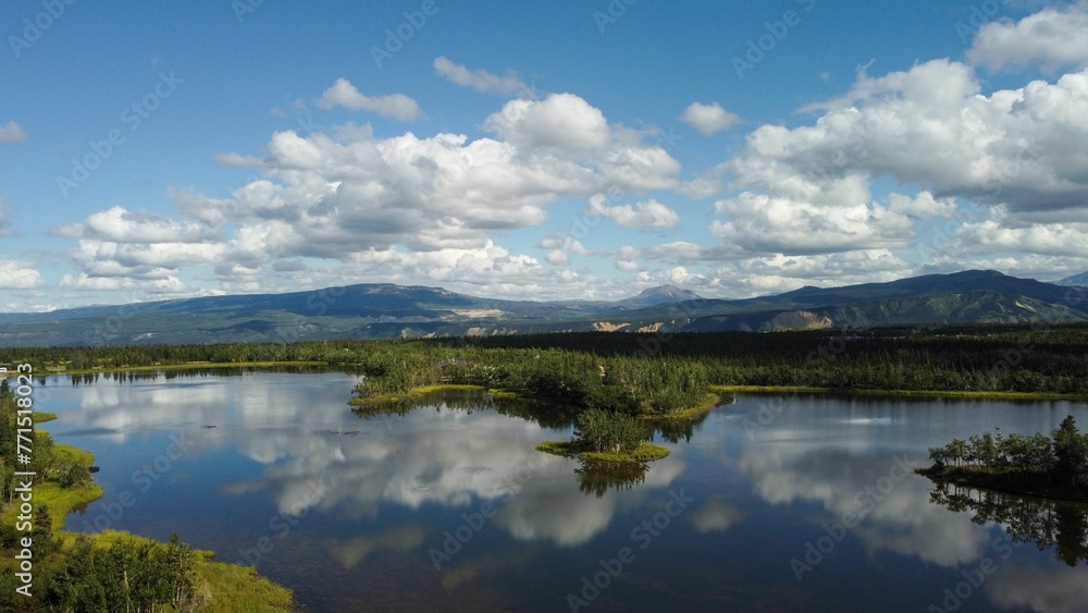 an aerial view of the mountains and trees across the Alaska Lake an aerial view of the mountains and trees across the Alaska Lake
