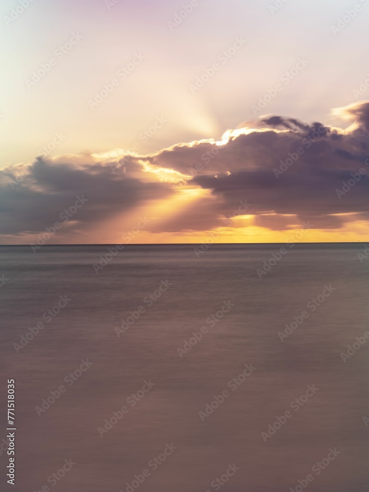 Majestic landscape with a beautiful sunny sky, with a tranquil ocean in the foreground