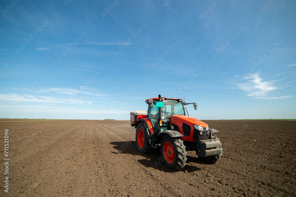 Tractor spreading artificial fertilizers Tractor spreading artificial fertilizers