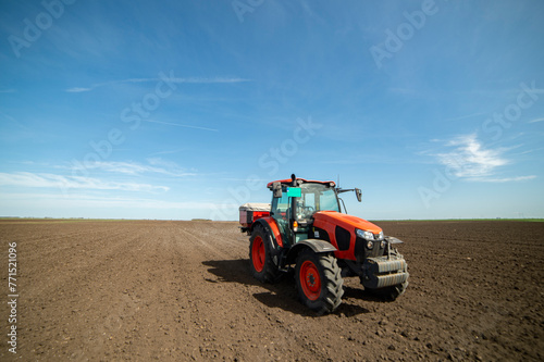 Fototapeta Naklejka Na Ścianę i Meble -  Tractor spreading artificial fertilizers