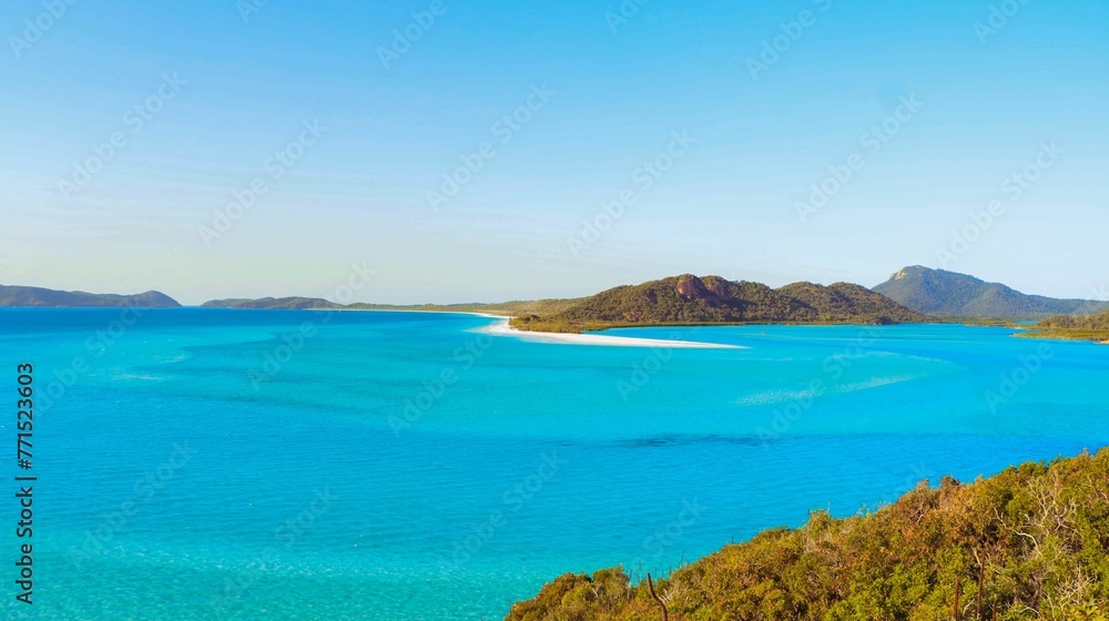 Picturesque view of a calm blue ocean from the peak of a mountain. Picturesque view of a calm blue ocean from the peak of a mountain.