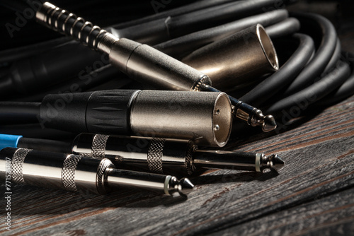 audio xlr trs cable plugs on wood background