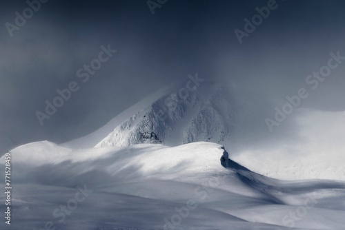 Picturesque winter landscape featuring snow-covered hills in Rondane National Park, Norway. photo