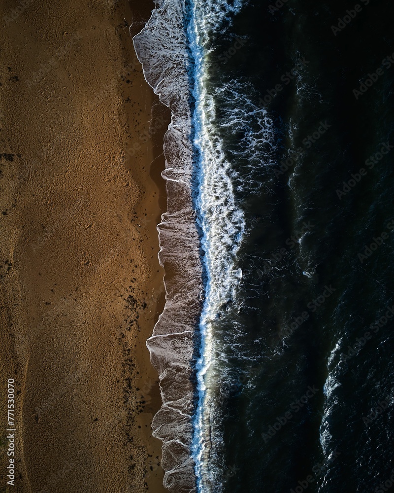 Scenic aerial shot of an ocean horizon with waves crashing onto the shoreline below. Scenic aerial shot of an ocean horizon with waves crashing onto the shoreline below.