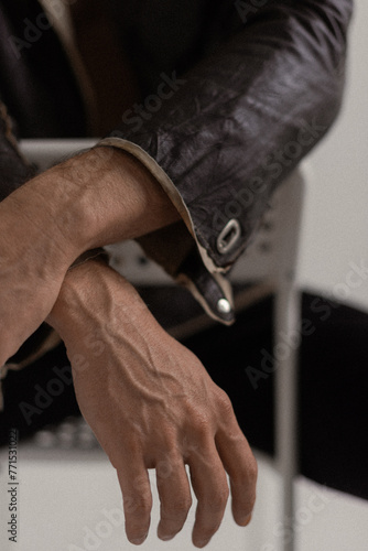 male hands of a man in a leather jacket