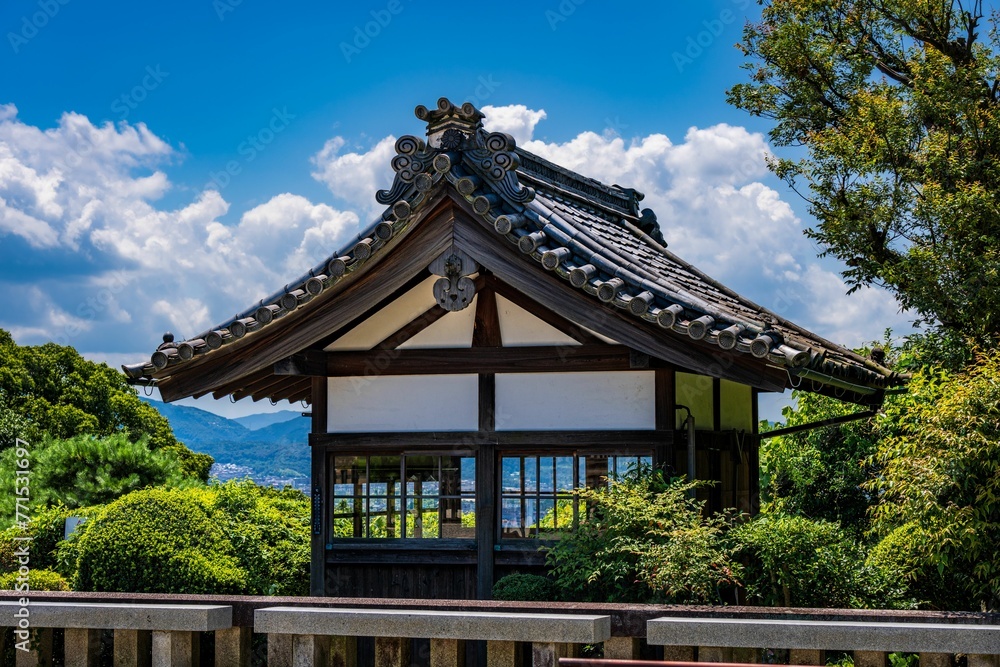 Traditional Chinese pagoda against a bright blue sky with white fluffy clouds in the background Traditional Chinese pagoda against a bright blue sky with white fluffy clouds in the background