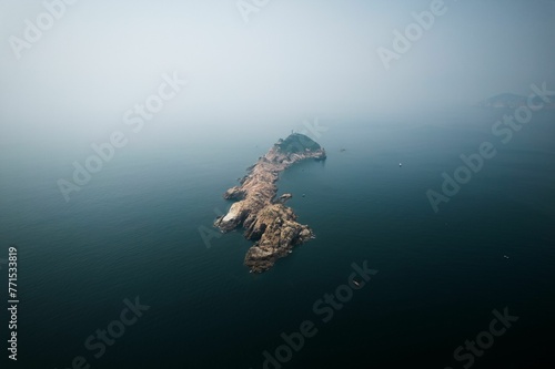 Aerial view of Waglan Island in Hong Kong surrounded by a vast body of clear blue water photo