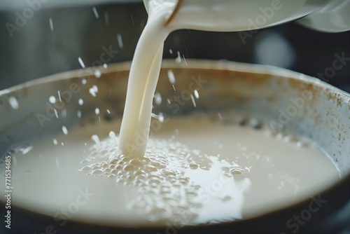 Closeup of milk pouring into a mug
