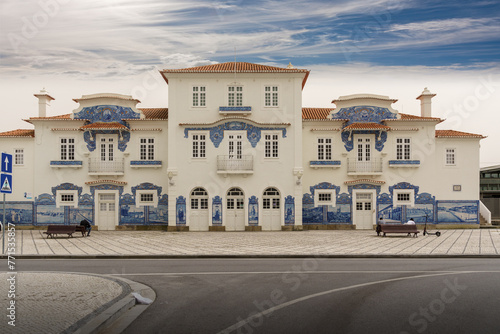 Exterior entrance view of a railway staion building ornately adorned with blue and white tiled frescos - aveiro portugal cerca 1911