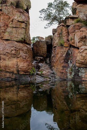 Scenic natural landscape featuring an array of rocky formations and vegetation in a tranquil lake