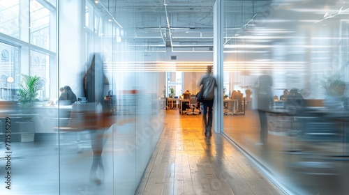 Blurred effect of office with people working behind glass wall