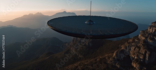 At the mountain's summit, a satellite dish signifies the fusion of innovation and rugged beauty. photo