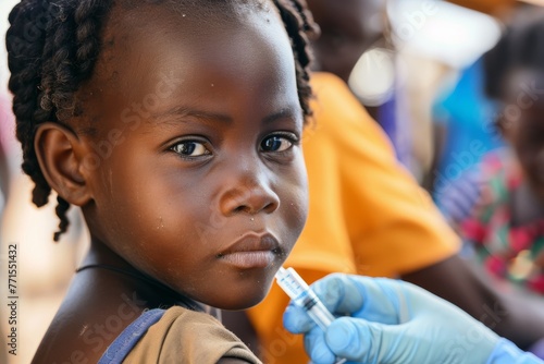 Young african girl child receiving a vaccine in a mobile health clinic in Africa being vaccinated in a community setting, highlighting the importance of public health and prevention