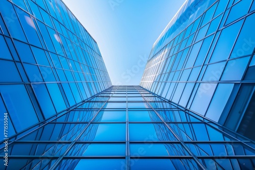 A tall building with many windows, and the sky is clear and blue