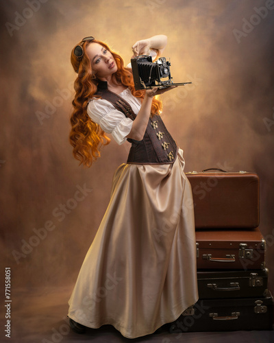 Red-haired girl in steampunk style with an old camera