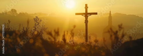 Golden sunlight creates a captivating silhouette of a Christian cross at sunrise.