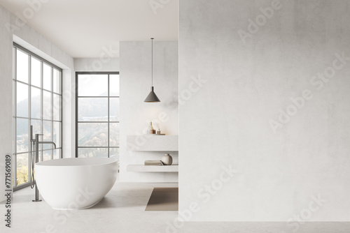 Luxury hotel bathroom interior with bathtub near panoramic window. Mockup wall