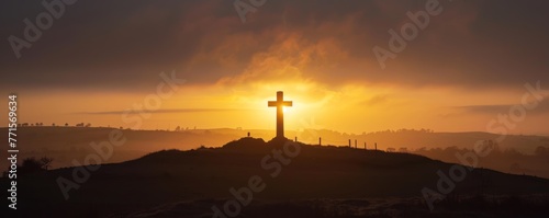 A hillside setting features a Christian cross under soft light.