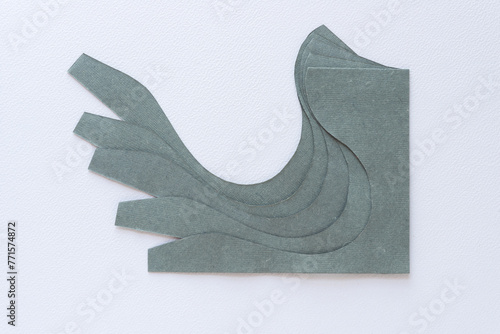abstract paper shape with elegant curve and wave edge arranged in a staggered pile on blank paper