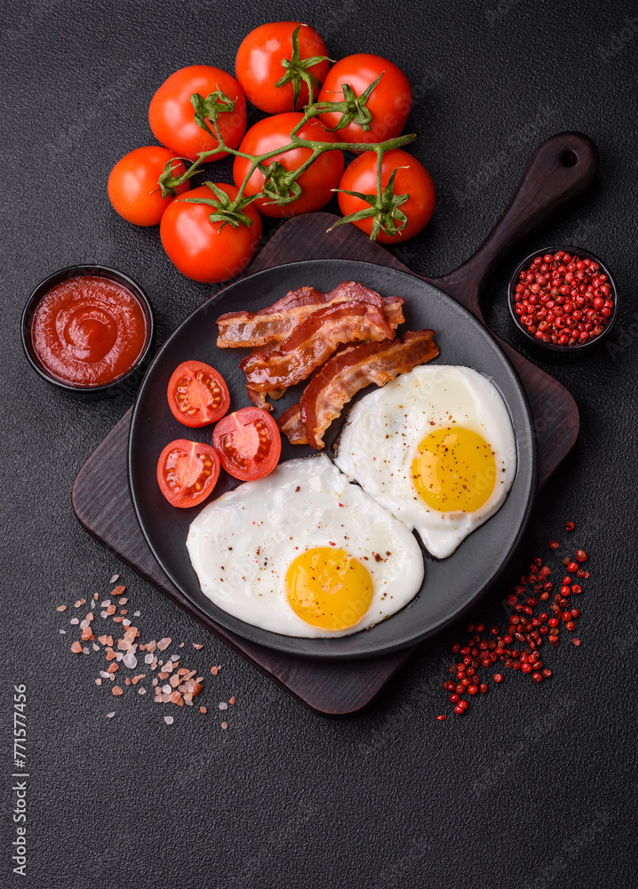 English breakfast with fried eggs, bacon, beans, tomatoes, spices and herbs English breakfast with fried eggs, bacon, beans, tomatoes, spices and herbs