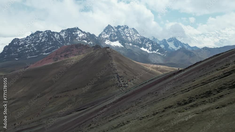 Drone shot moving backwards, showing a hill covered in snow with foreground hills. Drone shot moving backwards, showing a hill covered in snow with foreground hills.