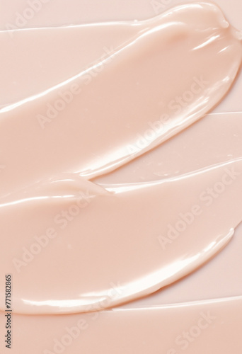Wallpaper with glossy realistic pink or beige texture of skincare or makeup product close up. Cosmetic smear, smudge, swatch of cream, lotion, serum, mask, balm, moisturizer macro background