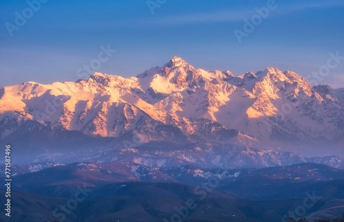 Mountain peak Nursultan former Komsomol  a beautiful mountain in the snow at sunset over the city of Almaty in Kazakhstan