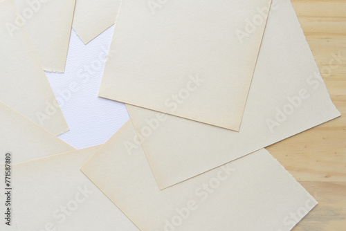 discolored white construction paper sheets with a torn edge  photo