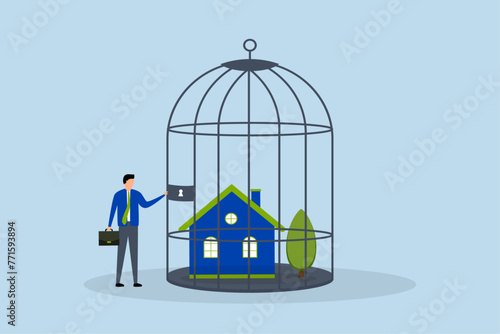 Mortgage payment problem, anxious homeowner businessman stands in a locked birdcage in his house.