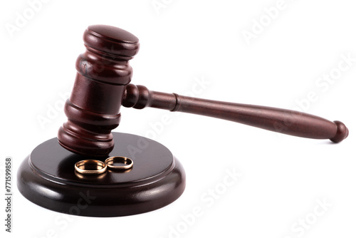 Golden wedding rings and judge's gavel on white background