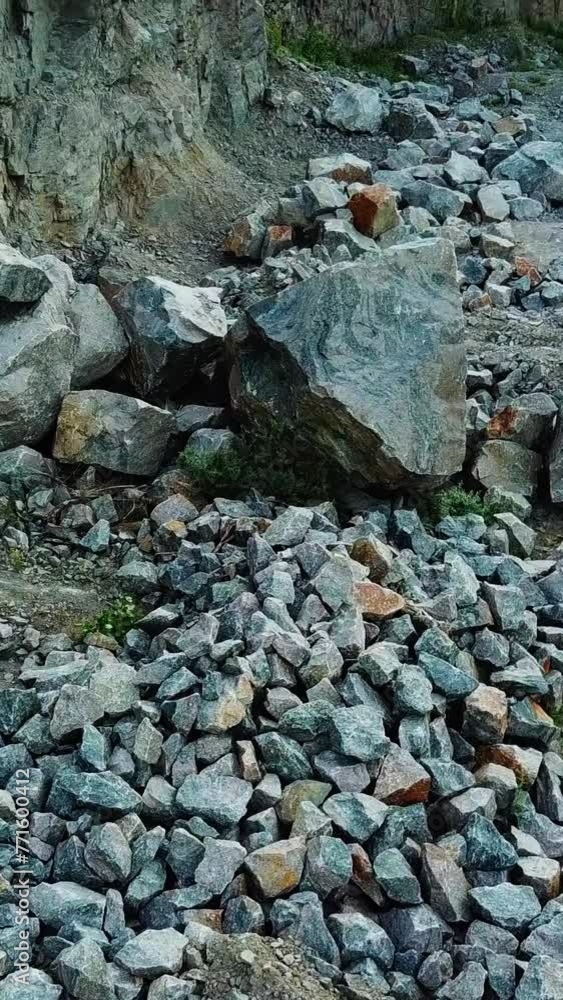 Hiker man going through the stone trail and comes into a rocky place. Aerial view of a tourist trekking in the mountains outdoors. Vertical video Hiker man going through the stone trail and comes into a rocky place. Aerial view of a tourist trekking in the mountains outdoors. Vertical video