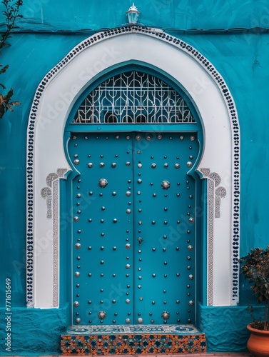 A blue and white building featuring a large blue door, standing out against its surroundings © pham