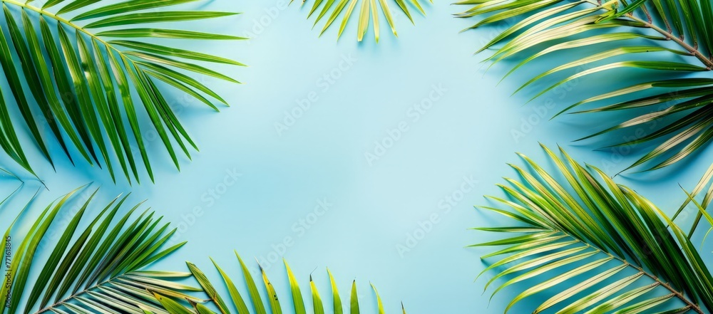 Vibrant green palm leaves contrast against a bright blue background