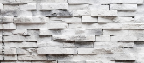 A closeup shot of a rectangular grey brick wall showcasing the intricate brickwork pattern and material properties of the building material