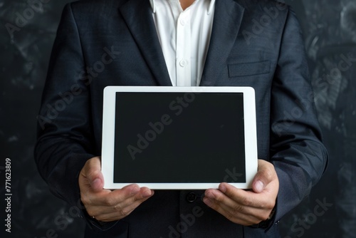 Product presentation. Promotion. Business man holding in hands tablet computer with blank screen