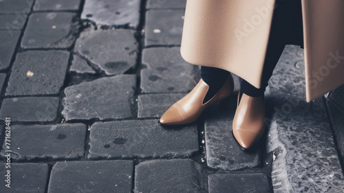 fashionable beige shoes in operation. women's legs in beige shoes close-up on a city street. quiet luxury in clothes.