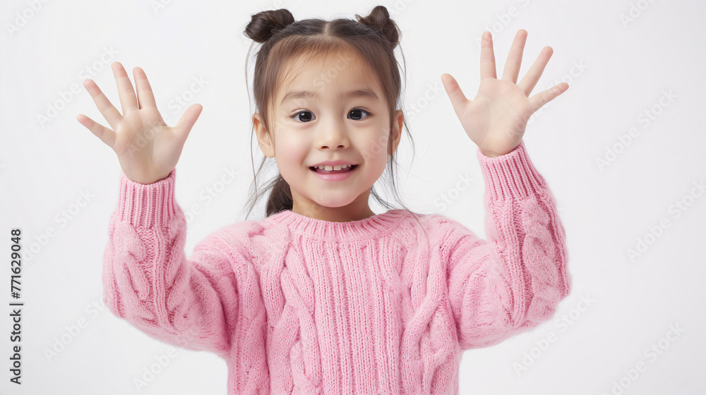 Cheerful Young Girl with Open Hands in Cozy Pink Sweater Isolated on a White Background Cheerful Young Girl with Open Hands in Cozy Pink Sweater Isolated on a White Background