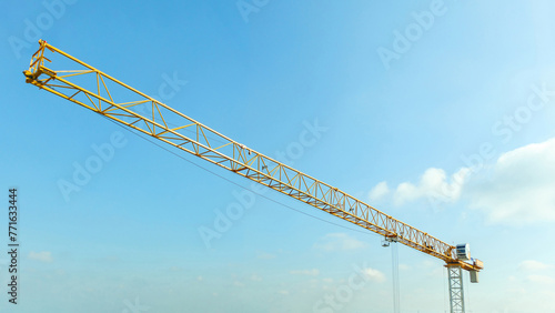 Industrial construction crane with blue sky background at building site