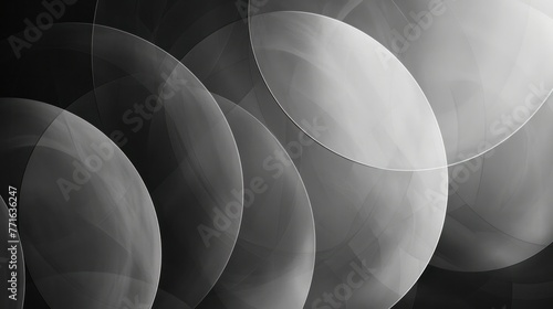 Abstract grayscale image featuring overlapping translucent circles with varying shades of light and shadow, creating a dynamic layered effect. photo