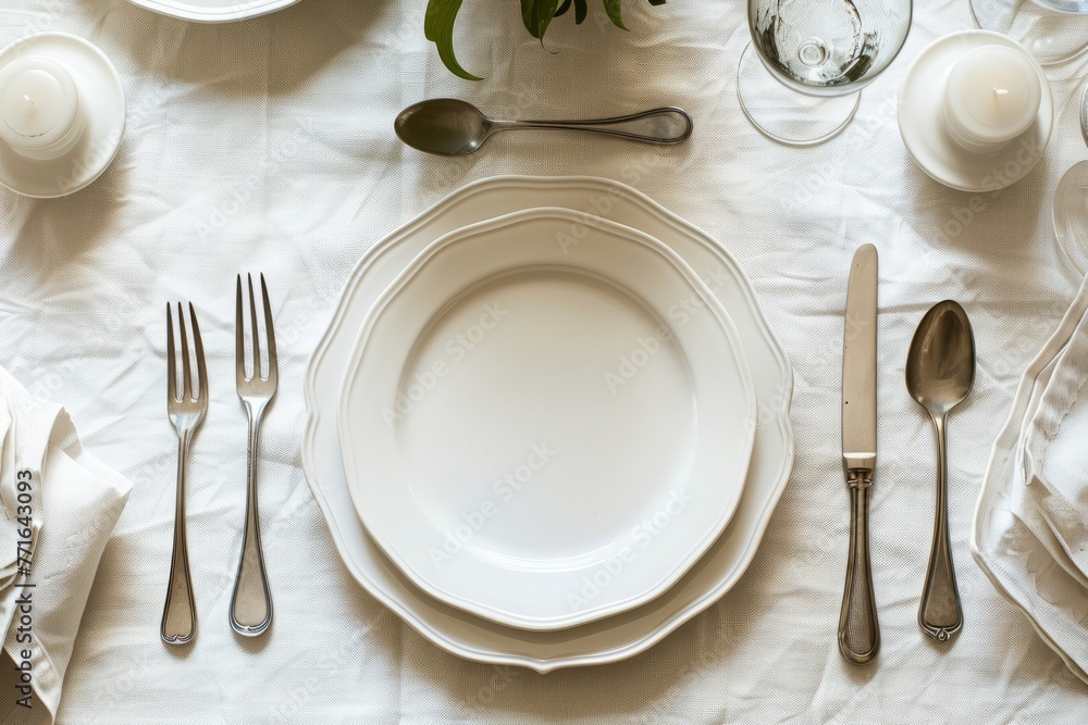 Panoramic view of a table set with white plates and silverware