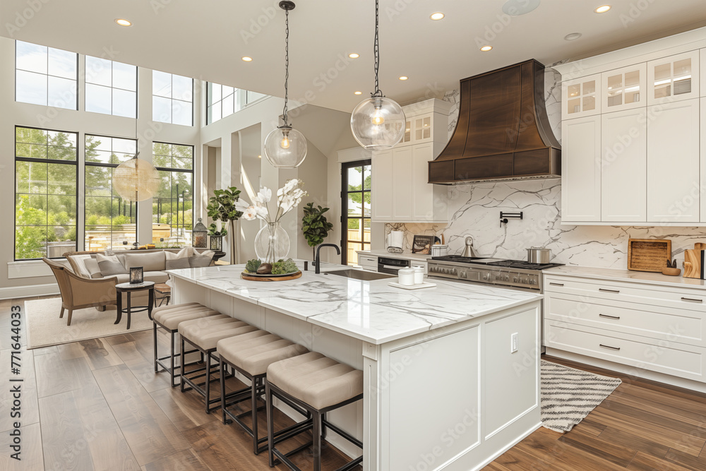 modern kitchen with island in the middle, panoramic windows that rise to the second floor, retro hood and globular chandeliers