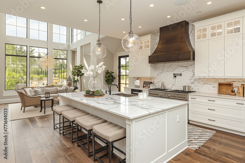 modern kitchen with island in the middle, panoramic windows that rise to the second floor, retro hood and globular chandeliers © Collorio