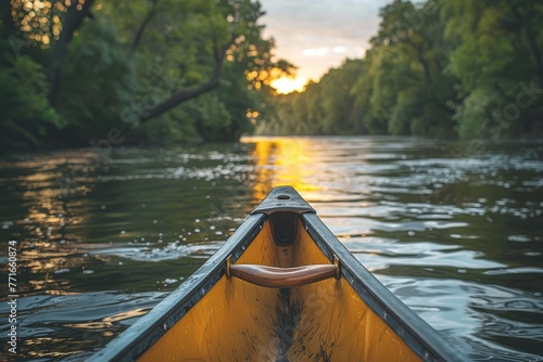 A calm river journey captured from the canoe's bow, focusing on the tranquil waters and sunset glow