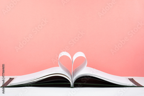 Bild auf Leinwand Old open hardback book, page decorate into a heart shape for love in Valentine's