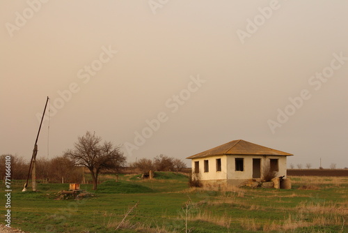 A house in a field with Arlington House, The Robert E. Lee Memorial in the background photo