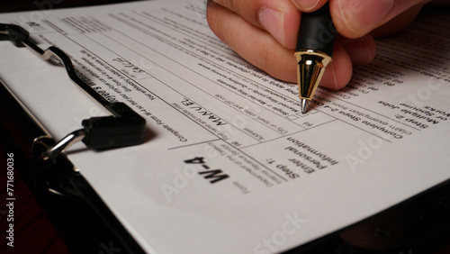 17 photo hispanic male hand filling out writing w4 irs tax employee form