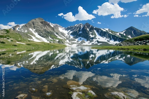 Pristine Alpine Lake Reflecting Snow Capped Peaks